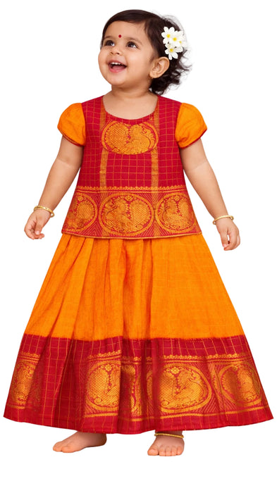 Child wearing a traditional red and orange dress 