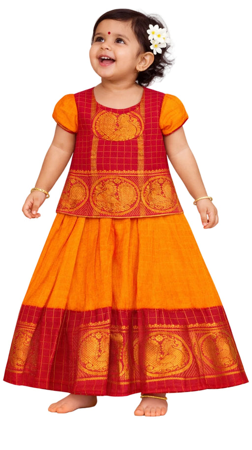 Child wearing a traditional red and orange dress 